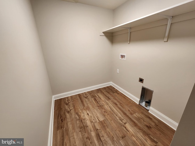 laundry area with laundry area, washer hookup, wood finished floors, baseboards, and electric dryer hookup