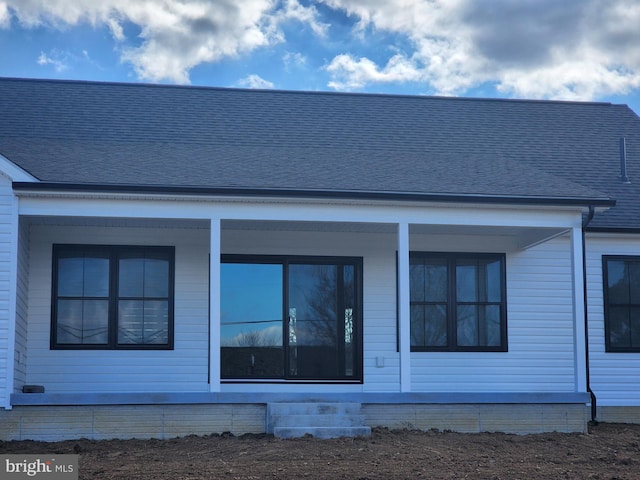 view of front of property featuring roof with shingles