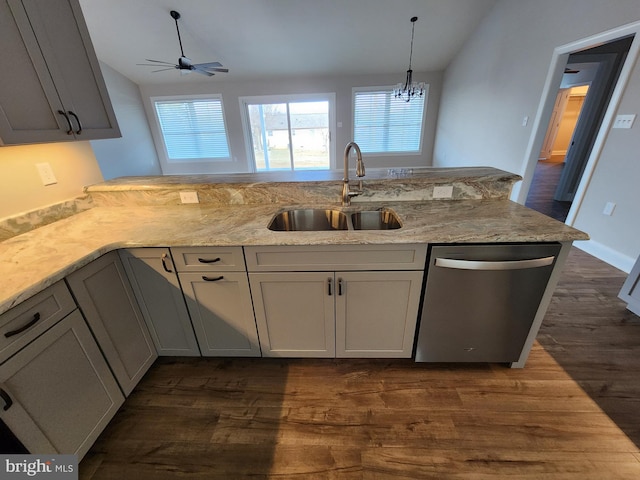 kitchen featuring dishwasher, vaulted ceiling, a sink, and dark wood finished floors