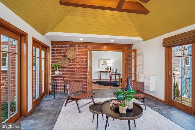 sunroom / solarium with lofted ceiling and wood ceiling