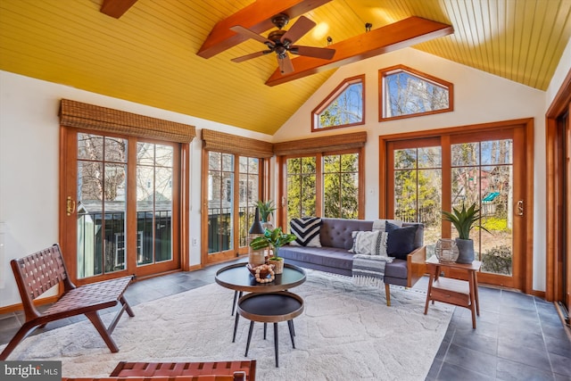 sunroom featuring lofted ceiling, wooden ceiling, and ceiling fan