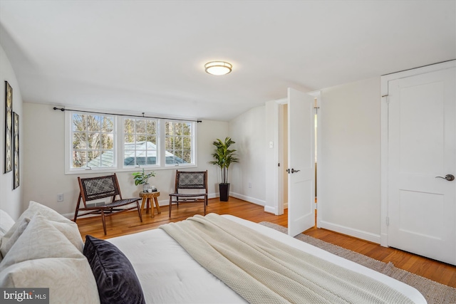 bedroom featuring baseboards and wood finished floors