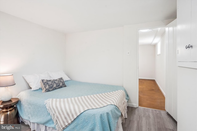 bedroom with wood finished floors and baseboards