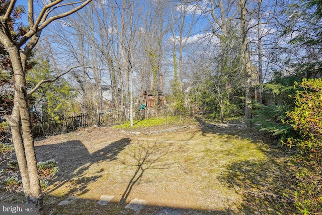 view of yard with fence and a playground