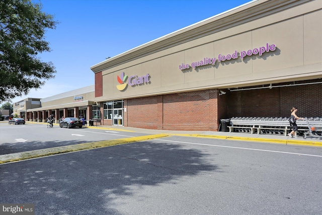 view of building exterior featuring uncovered parking