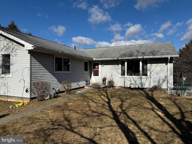 view of front of house with entry steps and a front lawn