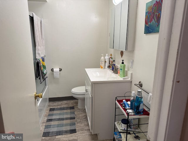 full bathroom with baseboards, vanity, toilet, and tub / shower combination