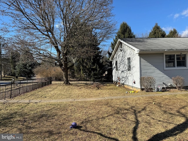 view of side of home featuring fence