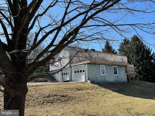 view of home's exterior with a lawn and an attached garage