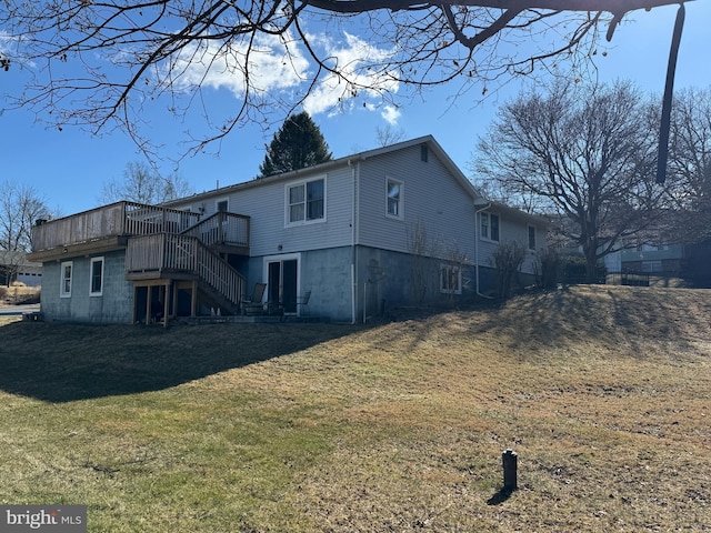 rear view of property featuring a wooden deck, stairway, and a yard