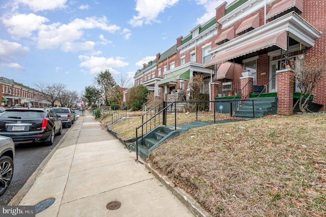 exterior space featuring a residential view, curbs, and sidewalks