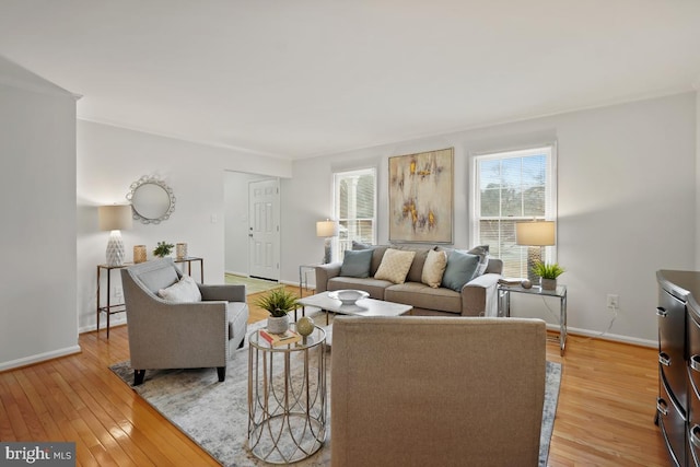 living area featuring light wood-style flooring and baseboards