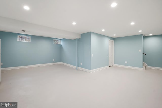 finished basement featuring recessed lighting, baseboards, and stairs