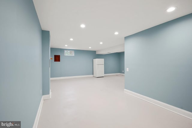 interior space with baseboards, concrete flooring, and recessed lighting