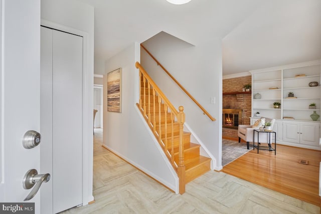 interior space featuring parquet floors, stairs, and a fireplace