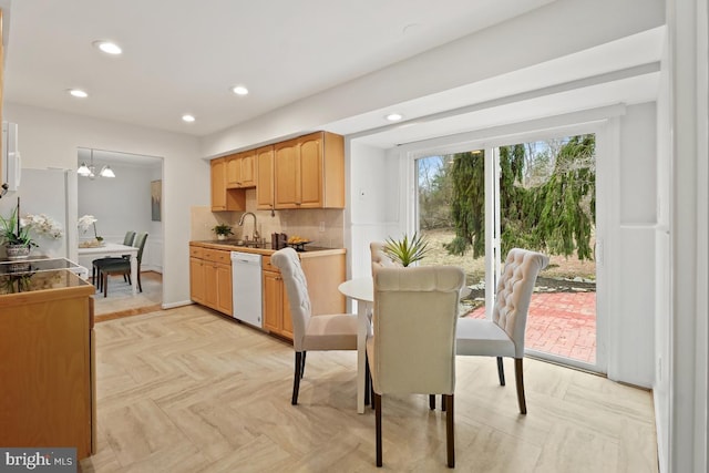 kitchen featuring recessed lighting, white appliances, a sink, light brown cabinetry, and tasteful backsplash