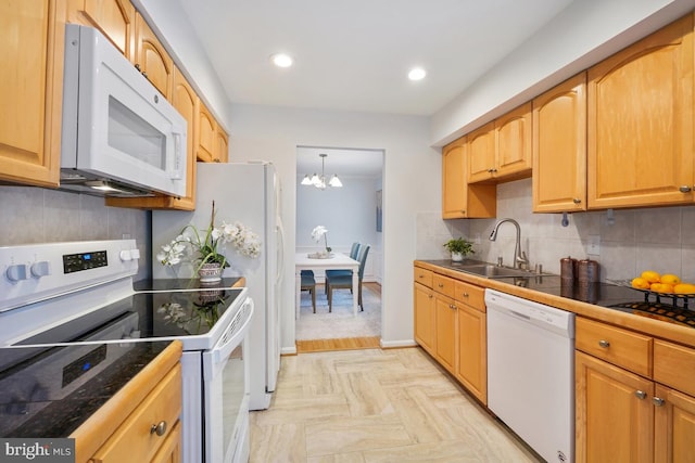 kitchen with tasteful backsplash, recessed lighting, an inviting chandelier, a sink, and white appliances