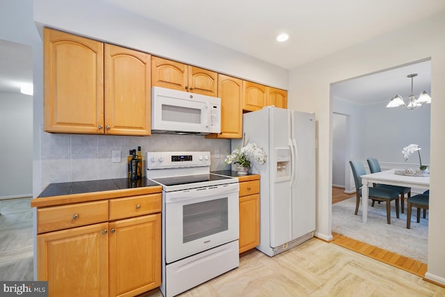 kitchen featuring white appliances, baseboards, decorative backsplash, a notable chandelier, and recessed lighting