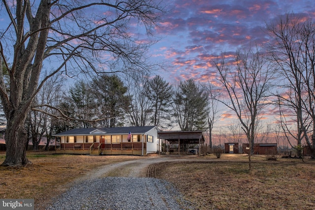 single story home with gravel driveway