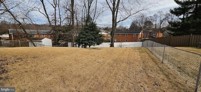 view of yard featuring a residential view and fence