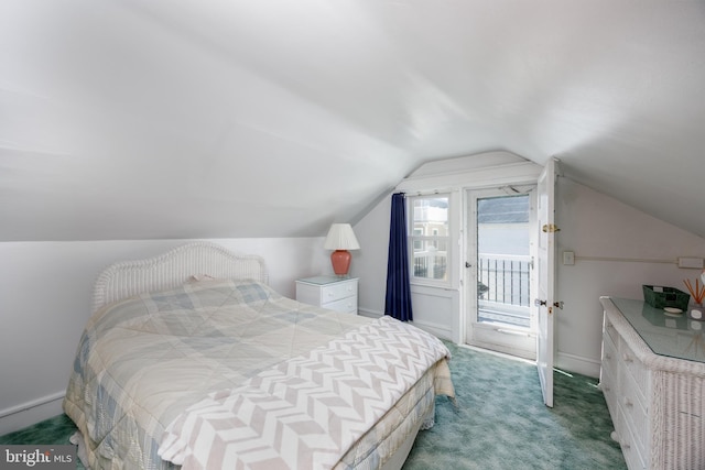 carpeted bedroom featuring lofted ceiling, baseboards, and access to exterior