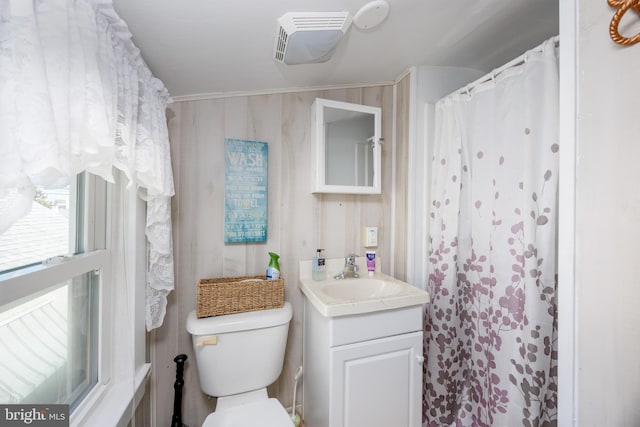 bathroom with toilet, vanity, and visible vents