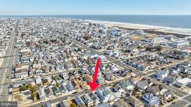 birds eye view of property with a beach view, a water view, and a residential view