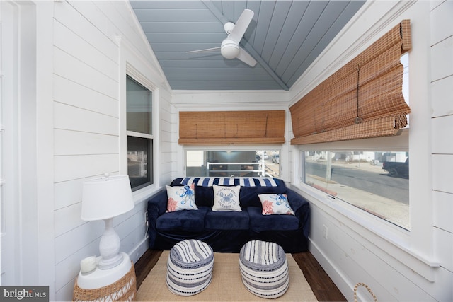 sunroom with lofted ceiling, wooden ceiling, and a ceiling fan