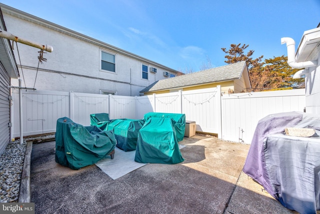 view of patio / terrace with a fenced backyard and a grill