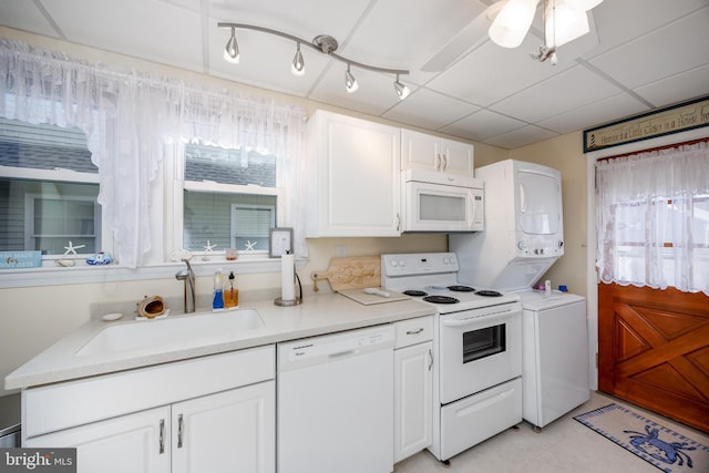 kitchen featuring light countertops, white appliances, a sink, and white cabinets