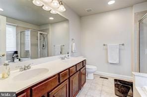 full bath with tile patterned flooring, a sink, a shower stall, and double vanity