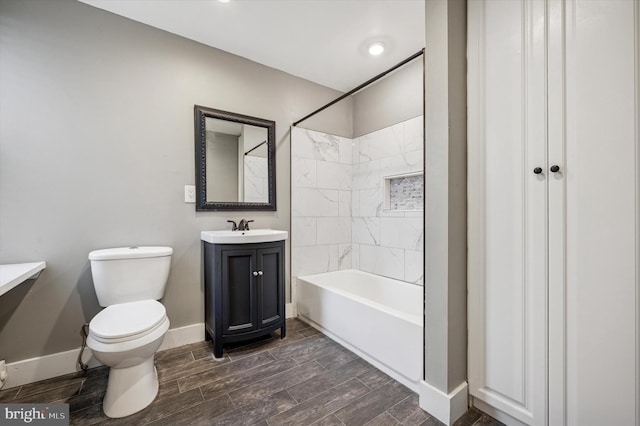 full bathroom featuring baseboards, toilet, vanity, shower / bathtub combination, and wood finish floors