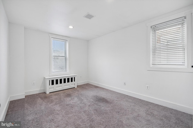 spare room featuring carpet floors, baseboards, visible vents, and recessed lighting