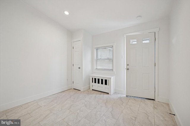 foyer with marble finish floor, recessed lighting, and baseboards