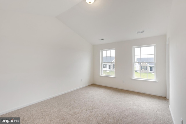 unfurnished room with baseboards, visible vents, and light colored carpet