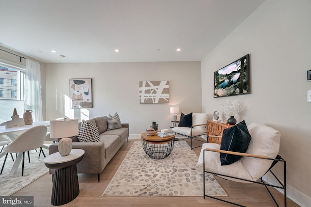 living room featuring baseboards, wood finished floors, and recessed lighting