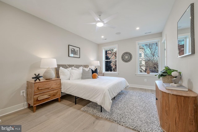 bedroom featuring visible vents, baseboards, a ceiling fan, light wood-style floors, and recessed lighting