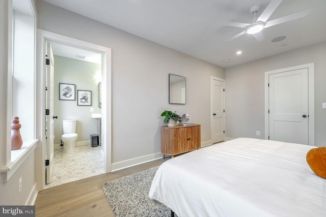 bedroom with visible vents, baseboards, ensuite bath, light wood-style flooring, and recessed lighting