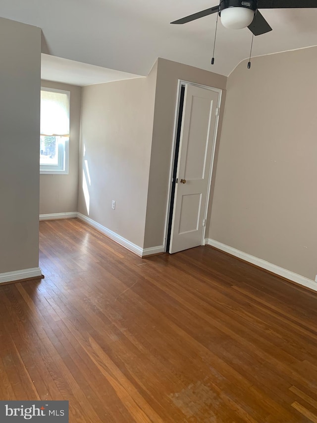 spare room featuring hardwood / wood-style flooring, ceiling fan, and baseboards