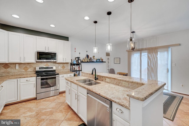 kitchen with tasteful backsplash, recessed lighting, appliances with stainless steel finishes, white cabinetry, and a sink