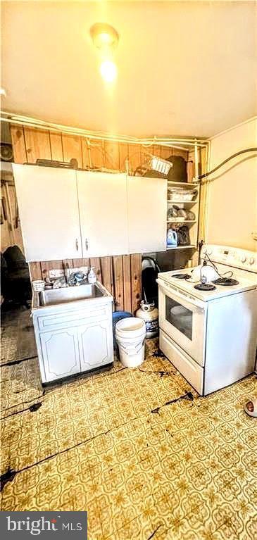 kitchen with electric stove and a sink