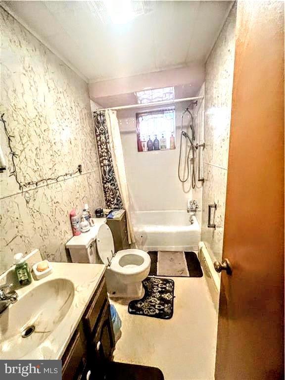 full bathroom with toilet, shower / bathtub combination with curtain, tile walls, and vanity