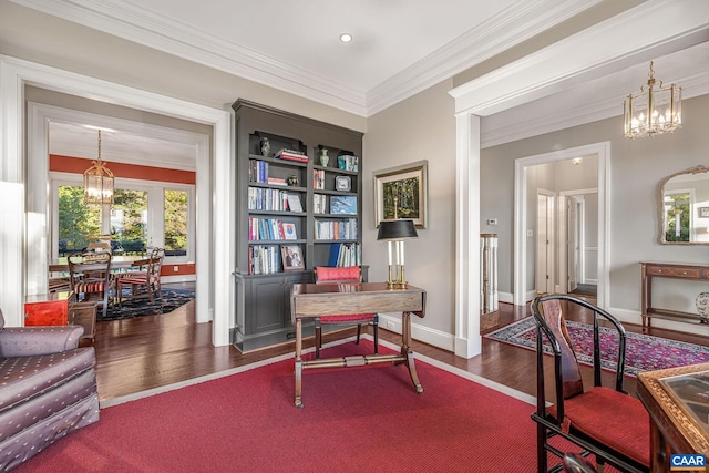 office area with a chandelier, ornamental molding, baseboards, and wood finished floors