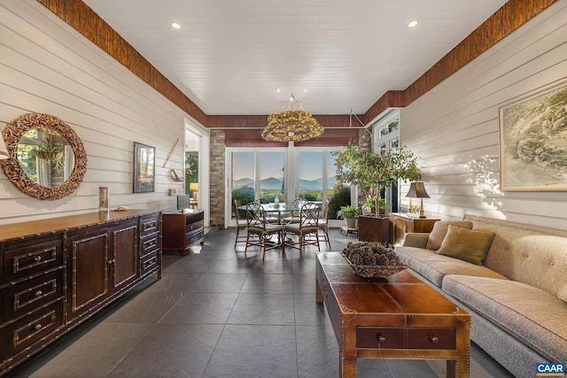 living area featuring recessed lighting and wood walls