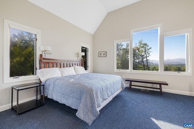 bedroom with dark carpet, vaulted ceiling, and baseboards