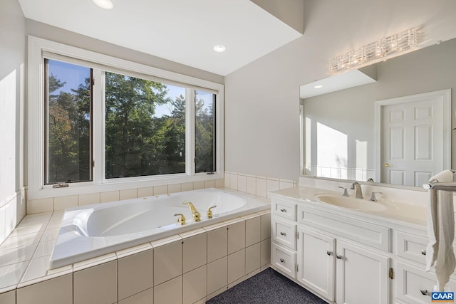 full bath with a garden tub, recessed lighting, and vanity