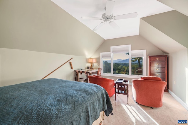 bedroom with lofted ceiling, light carpet, ceiling fan, a mountain view, and baseboards