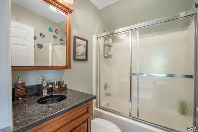 full bathroom with shower / bath combination with glass door, vanity, and toilet