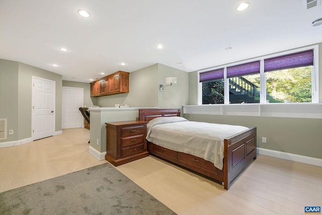 bedroom featuring recessed lighting, visible vents, light wood finished floors, and baseboards