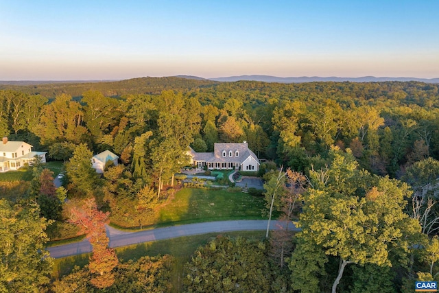 drone / aerial view featuring a forest view